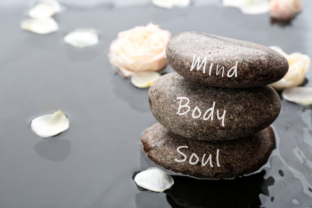 stones,with,words,mind,,body,,soul,and,flower,petals,in