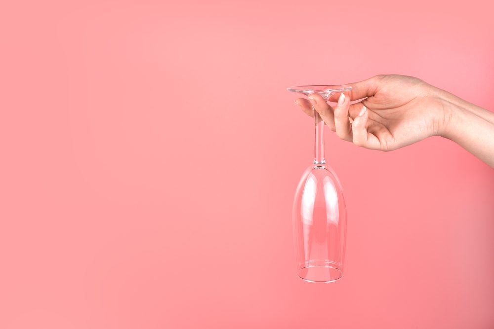 abstract,background,with,a,woman's,hand,holding,a,champagne,glass