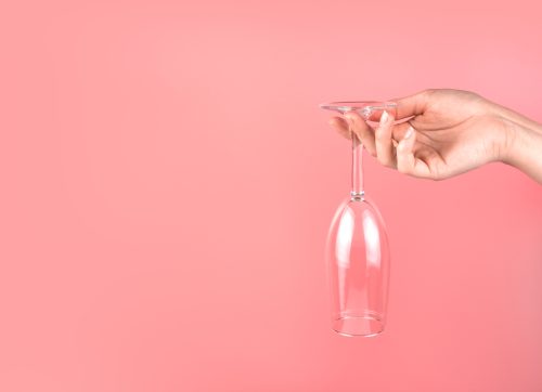 abstract,background,with,a,woman's,hand,holding,a,champagne,glass