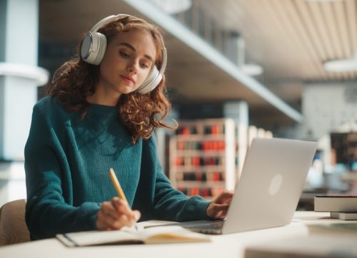concentrated,young,female,student,engaged,in,academic,research,with,laptop