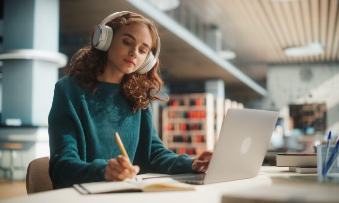 concentrated,young,female,student,engaged,in,academic,research,with,laptop