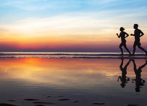 two,runners,on,the,beach,,silhouette,of,people,jogging,at