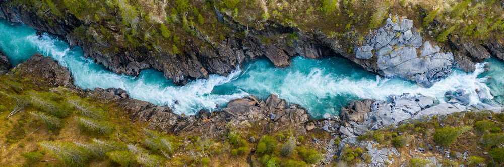 aerial,vertical,view,over,the,surface,of,a,mountain,river