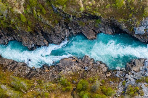 aerial,vertical,view,over,the,surface,of,a,mountain,river