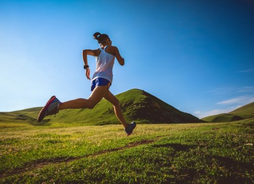 young,fitness,woman,trail,runner,running,on,high,altitude,grassland