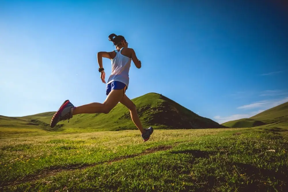 young,fitness,woman,trail,runner,running,on,high,altitude,grassland